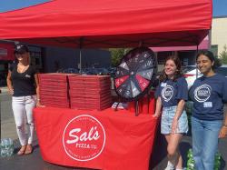 Sal's Pizza handing out free pizza with a chance to win a free prize. Photo courtesy of Boston Community Pediatrics.