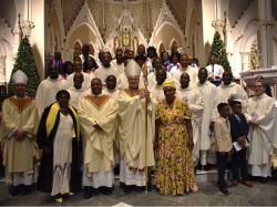 Archbishop Richard Henning poses for photos with the Haitian clergy and choir after presiding at Mass for the Haitian community on the occasion of New Years Day and Haitian Independence Day. Photo by Patrick O'Connor.